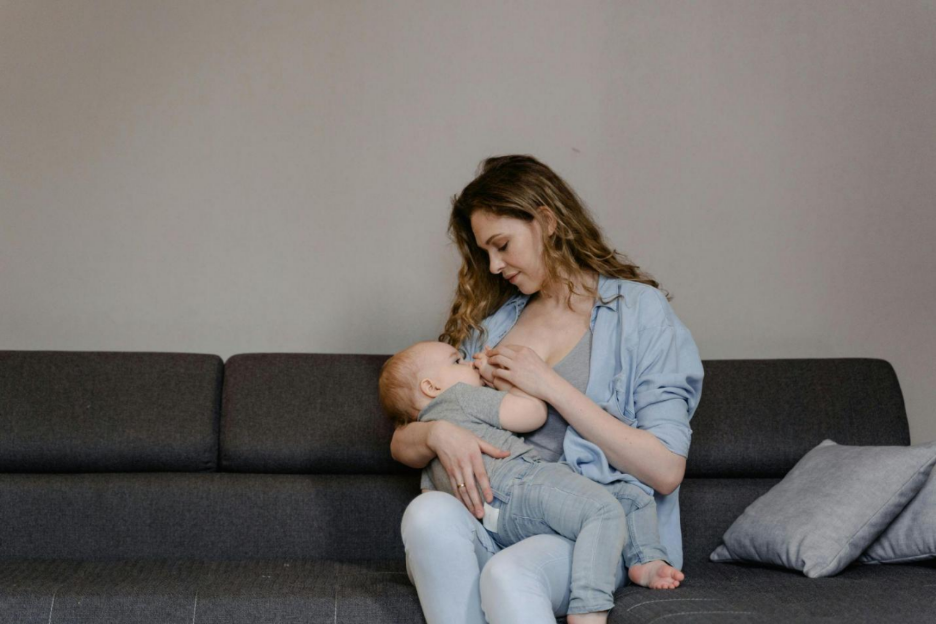Mother breastfeeding her baby at home before starting a power pumping routine